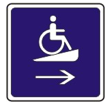 Placard directing wheel chair users to a ramp.