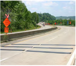 Temporary rumble strips affixed to a two-lane roadway in advance of a work zone.